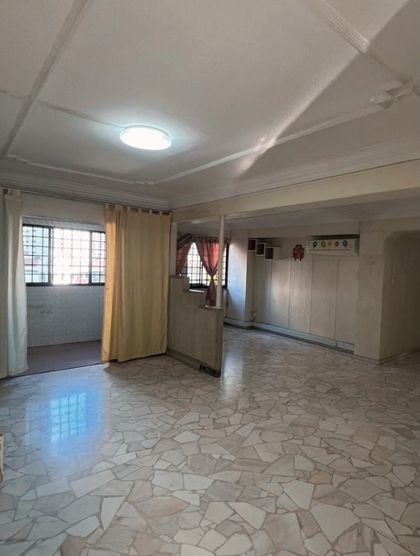 Before: a dated living room with terrazzo-chip flooring, yellow curtains and an ornate plaster ceiling.