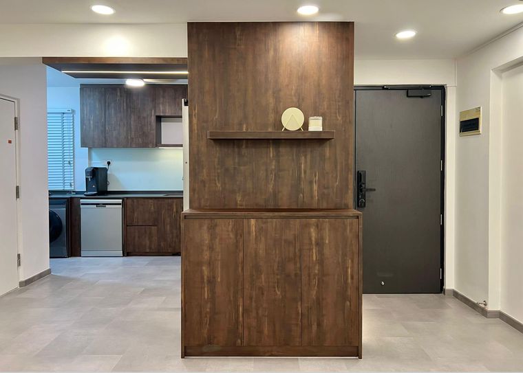 Entrance foyer with a freestanding dark-walnut partition and floating shelf screening the kitchen beyond.